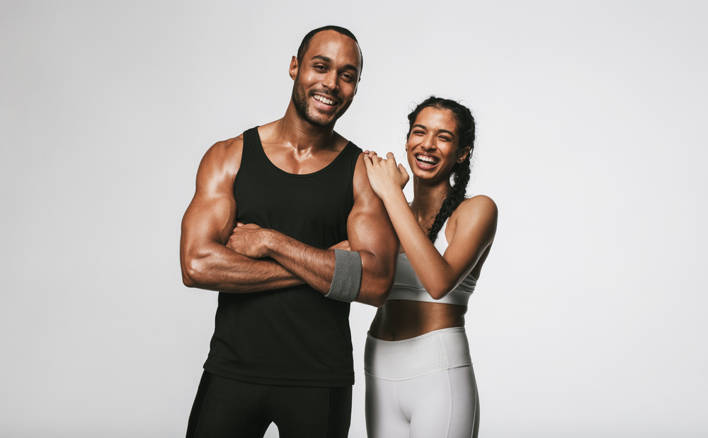 Smiling,Couple,In,Fitness,Wear,Standing,Against,White,Background.,Fit 310cfc4bab594d2195607d50c1987ffe