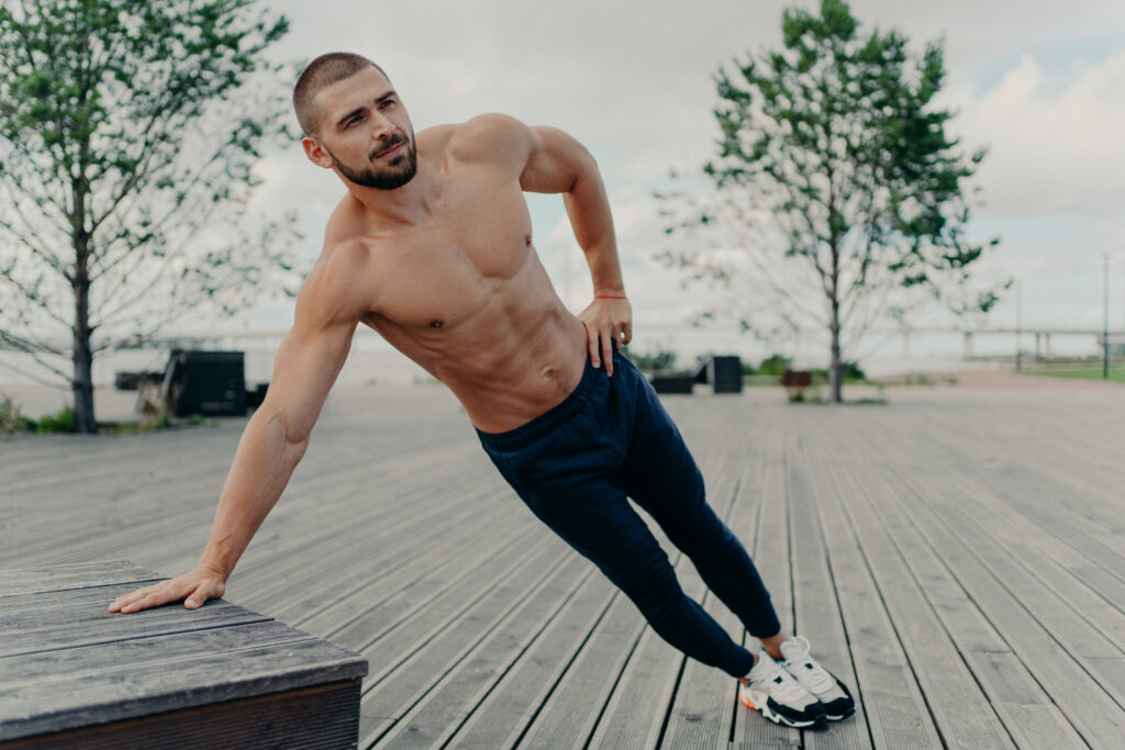 A shirtless man exercising and showing the results of the Metabolism Boost Complex IV