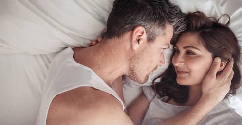 A close-up shot of a man and woman in bed